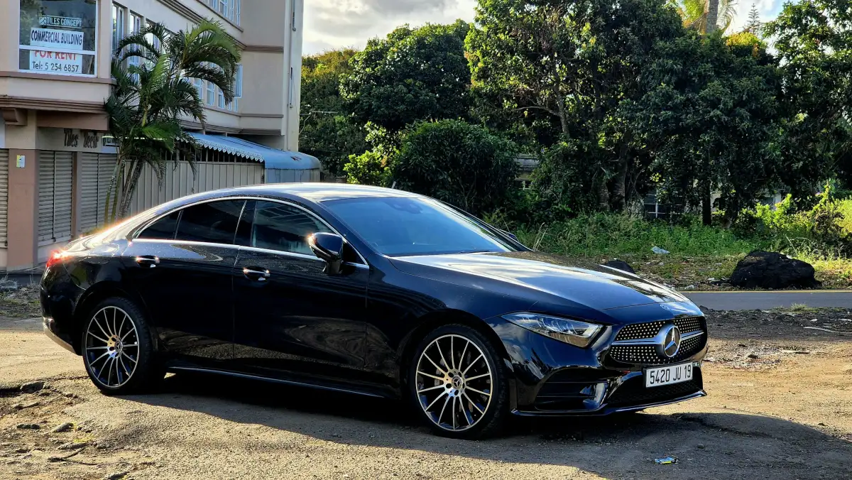 A black car parked in front of a building